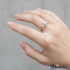 Elegant Rose Gold Three-Stone Halo Ring