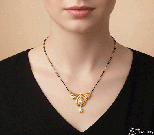Gold-plated mangalsutra with a teardrop pendant featuring intricate gold and stone detailing
