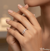 Lumina Double-Row Ring worn on a woman’s hand, featuring a sleek wave design with pavé-set american diamonds on a polished white metal band.